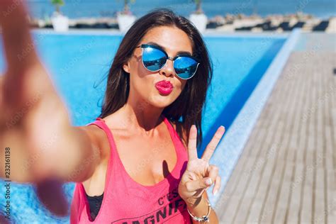 Close Up Selfie Portrait Of Attractive Brunette Girl With Long Hair Standing Near Pool She