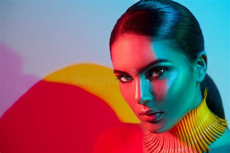 Fashion Model Woman In Colorful Bright Lights With Trendy Makeup And