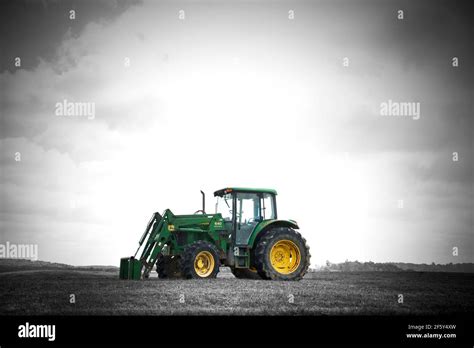 John Deere Green Tractor On The Farm At Sunset In Black And White With