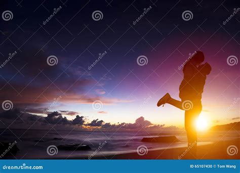 Silhouette Of Young Couple In Love Hugging On Beach Stock Photo Image