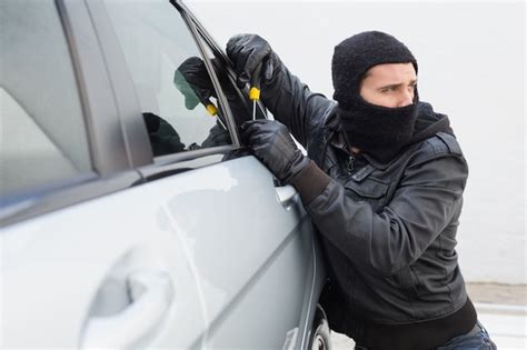 Premium Photo Thief Breaking Into Car With Screwdriver