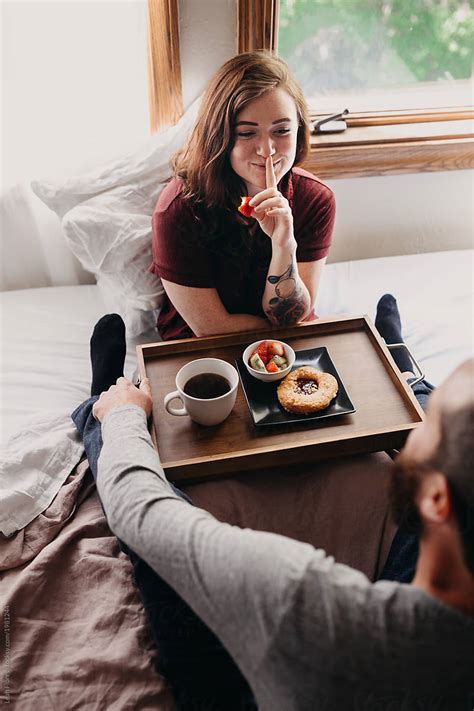flirty couple in bed with breakfast by stocksy contributor leah flores stocksy