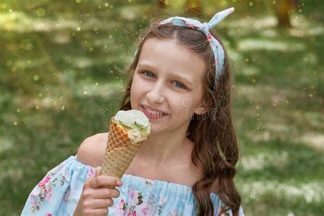 Portrait Of A Beautiful Brunette Girl With Sweet Ice Cream With A Waffle Cone Stock Image