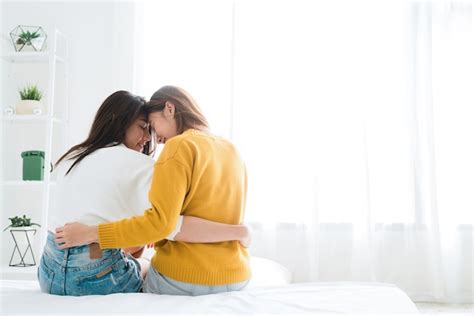 Premium Photo Asia Lesbian Lgbt Couple Hug And Sitting On Bed Near White Window With Happiness