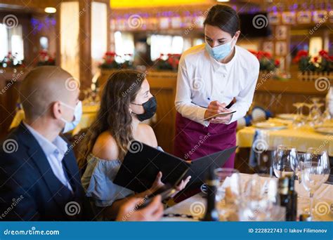 Positive Young Couple Making Order At Restaurant Stock Image Image Of
