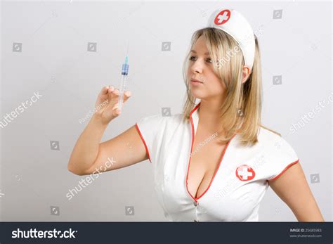 Стоковая фотография 25685983 Sexy Young Woman Dressed Nurse Holding