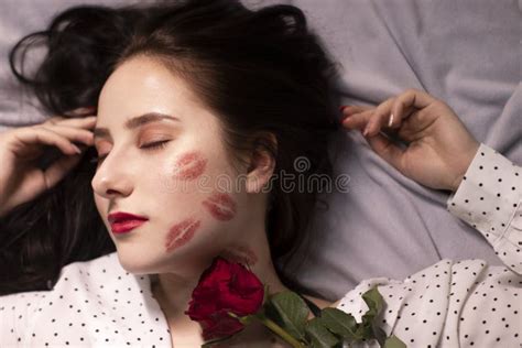 Brunette Woman With Kisses Lipstick Marks On Her Face And Neck With Red Rose Girlfriend Date