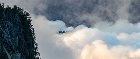 Download Wallpaper 2560x1080 Rock Trees Clouds Mountain Peak Dual