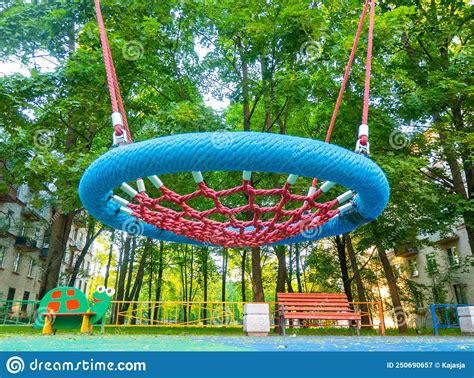 Round Swing Seat Made Of Mesh In Playground Empty Blue Rope Web Nest