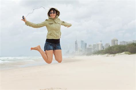 Happy Young Woman Jumps On The Beach Stock Photo Image Of Cord Jump