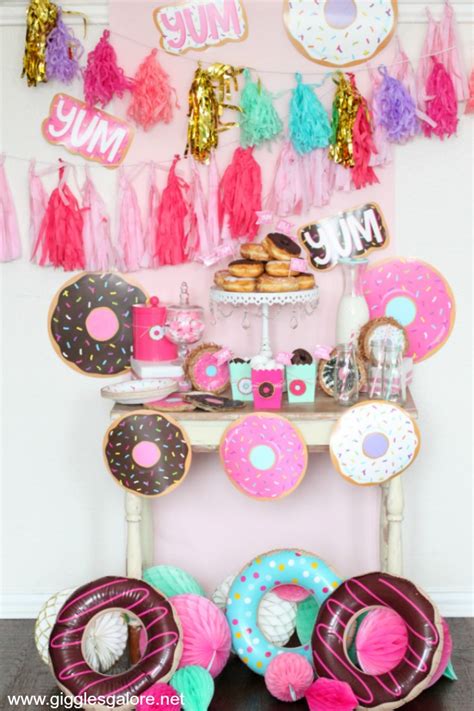Make donut themed party decorations, invite party guests decorate donuts, and hold a donut decorating contest. Cute and Simple Donut Themed Party - Giggles Galore