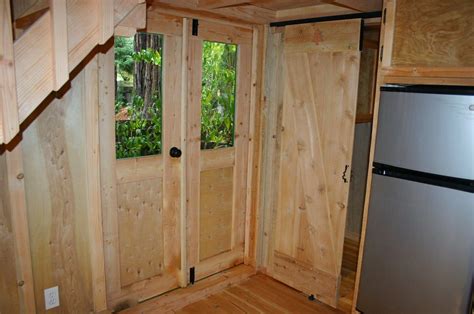 Steps leading to the left bedroom and the space below the workstation offer ample storage area and a small bathroom with white fixtures completes a beautiful and smart cabin that. New 9X20 Hunter green Cabin, with 10X12 studio. We build tiny homes custom to your ...