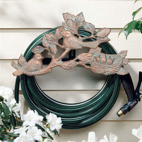 Holds up to 150' of ½ hose or 50' of 5/8 hose. Decorative Garden Hose Holders - HomesFeed