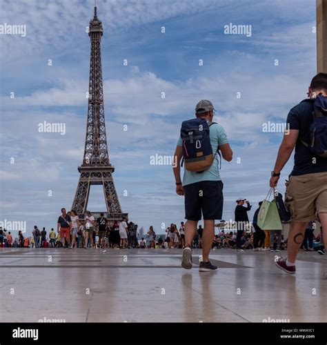 The Eiffel Tower In Paris France Filled With Tourists And Backpackers