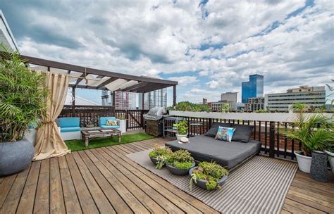 large rooftop deck in the south loop of chicago with city views wooden pergola daybed wicker