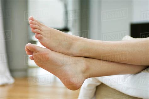 Woman S Bare Feet Legs Crossed At Ankle Stock Photo Dissolve My Xxx