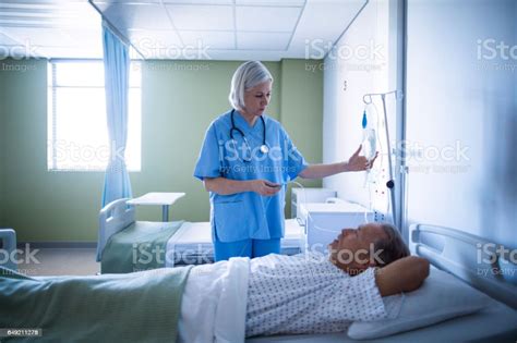Nurse Adjusting Male Patient S Iv Drip Stock Photo Download Image Now