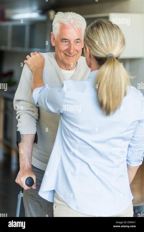 Elderly Man Walking With Crutches Stock Photo Alamy