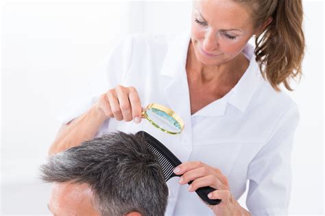 Dermatologist Looking At Patients Hair Vegas Valley Hair Restoration