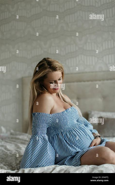 A Happy Pregnant Woman Touching Her Belly A Cheerful Expectant Woman