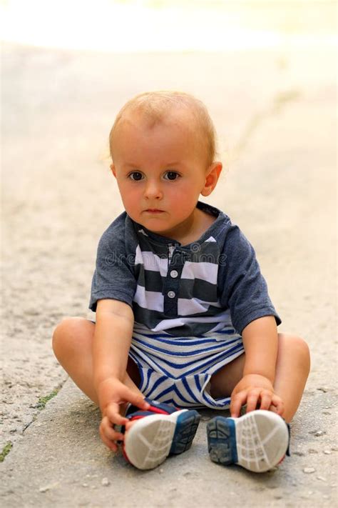 Baby Boy Sitting On The Floor In The Street Stock Image Image Of