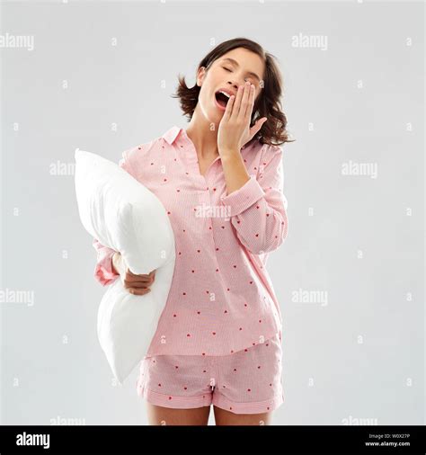 Sleepy Yawning Young Woman In Pajama With Pillow Stock Photo Alamy