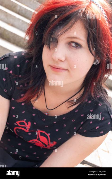 Punk Emo Girl Young Adult With Black Red Hair Looking At Camera