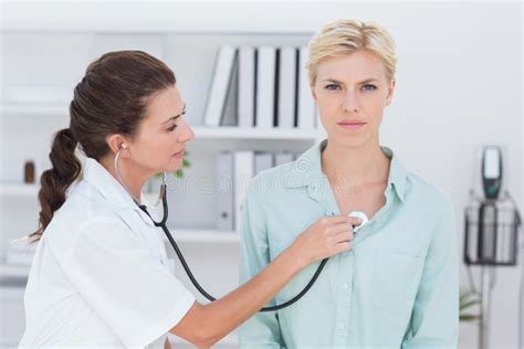 Doctor Listening To Patients Chest With Stethoscope Stock Photo Image