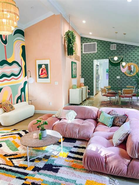 A Living Room Filled With Lots Of Furniture And Colorful Rugs On Top Of It
