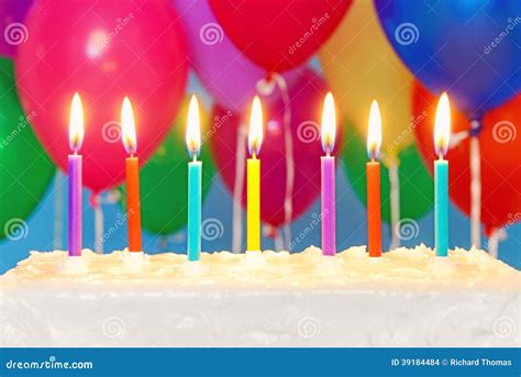 Candles On A Cake With Balloons In Background Stock Photo Image 39184484