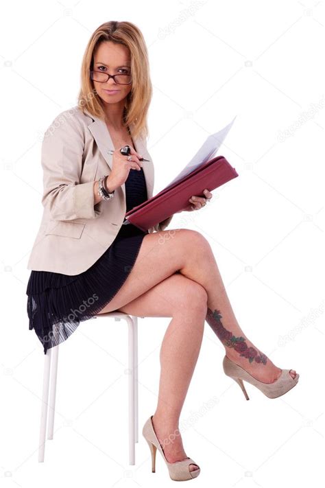 Beautiful Mature Woman Secretary Seated On A Bench Reading Some