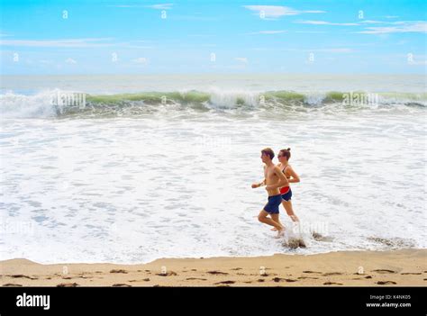 bali island indonesia jan 18 2017 beautiful couple running on the ocean beach on bali