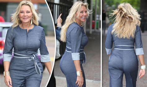 carol vorderman flaunts eye popping rear as she squeezes killer curves into tight jumpsuit