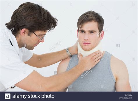 Male Doctor Examining A Patients Neck Stock Photo Alamy