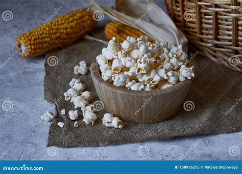 Traditional Popcorn In A Wooden Bowl And Corncobs On The Table Stock