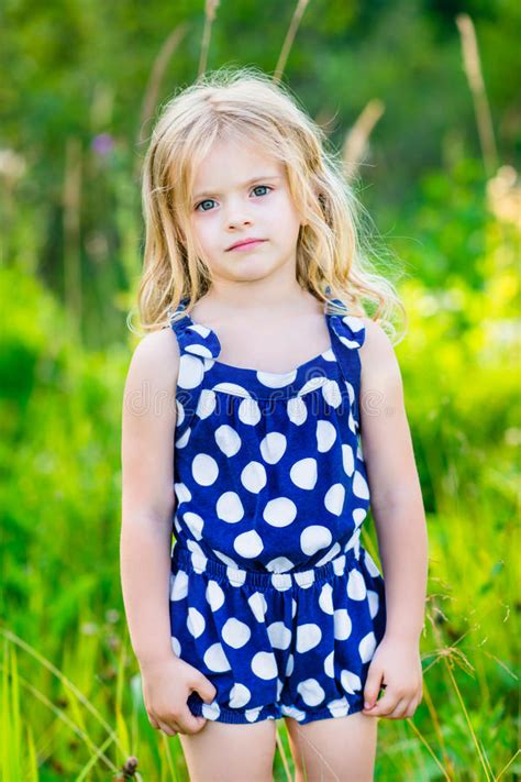 Cute Little Girl With Long Blond Curly Hair Outdoor