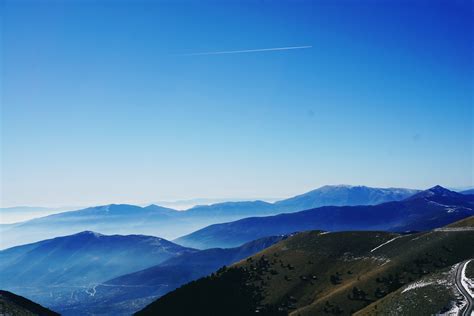 Green And Blue Fog Covered Mountains Under Blue Sky · Free Stock Photo