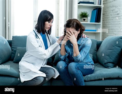 Female Doctor Comforting Depressed Crying Woman Patient Sitting