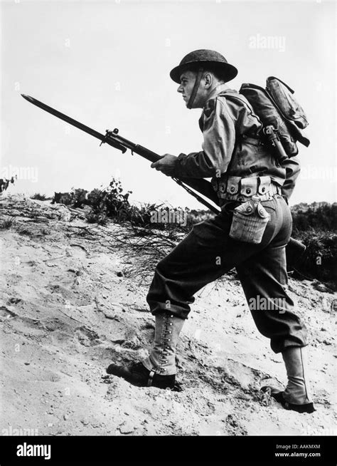 1940s 1942 World War Ii Soldier Walking Across Rough Terrain With Rifle