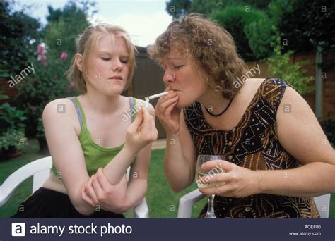 Mother Her 15 Year Old Daughter Smoking Cigarettes Together In The