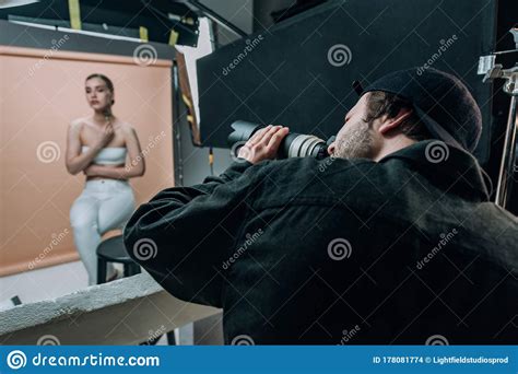 Focus Of Videographer Filming Female Model In Photo Studio Stock Photo