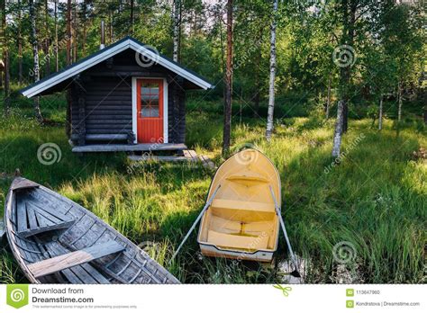 Traditional Wooden Hut Finnish Sauna On The Lake And Pier