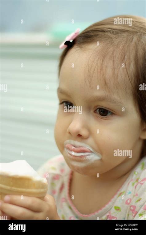 Portrait Of A Little Cute Girl Eating Ice Cream Stock Photo Alamy