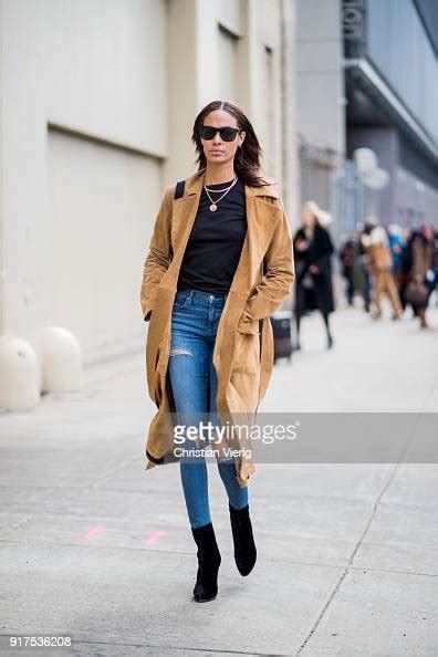 Model Joan Smalls Wearing Brown Trench Coat Blue Ripped Denim Jeans