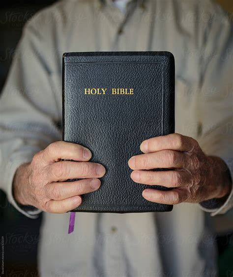 Hands Holding A Bible Del Colaborador De Stocksy David Smart Stocksy