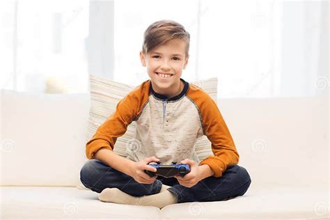 Happy Boy With Joystick Playing Video Game At Home Stock Photo Image