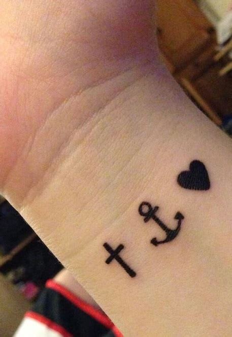 Black heart with cross and anchor tattoo on left wrist. Little black tattoos of heart, anchor and cross on wrist ...