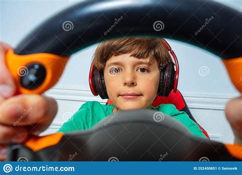 Through The Steering Wheel View Of Gamer Boy Play Race Game Stock Image