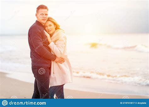beautiful romantic couple on a sunset on tropical beach and hugging on the seashore stock image