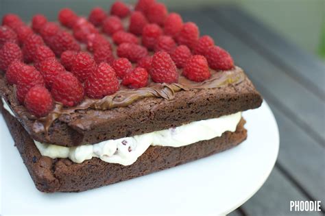 A Chocolate Cake With Raspberries And Whipped Cream